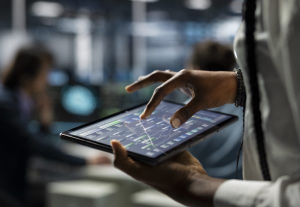 Close up of data center computer scientist using tablet, deploying servers Close up of data center computer scientist using tablet, deploying servers and network hardware. IT specialist in server farm using device to manage large scale IT infrastructure